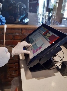 Touch screen equipped with a protective foil with protection against the deposition of organic and microbial pollutants I.